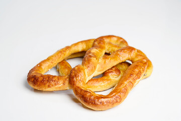 Salty baked brown pretzel isolated over a white background. Oktoberfest festival
