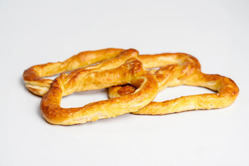 Salty baked brown pretzel isolated over a white background. Oktoberfest festival