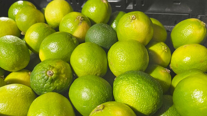 Fresh green lemons sold at the market.
