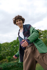 Handsome student enjoys a leisurely stroll in the lush greenery on a serene day