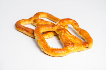 Salty baked brown pretzel isolated over a white background. Oktoberfest festival