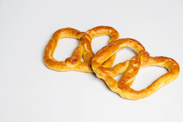 Salty baked brown pretzel isolated over a white background. Oktoberfest festival