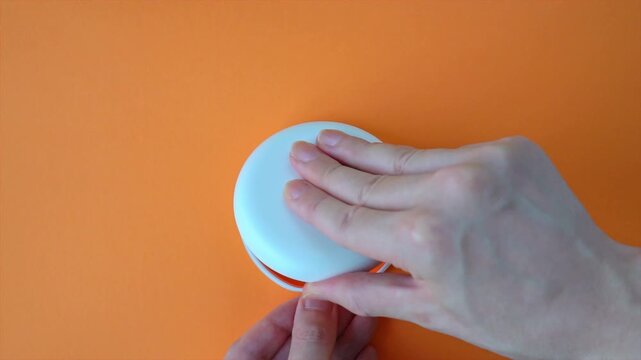  Opening White and Orange Dental Aligner Case that are Orthodontic Mouthpiece storage in orange background. Slow motion.