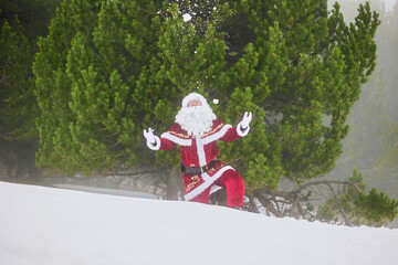 Santa Claus throwing snow in winter forest