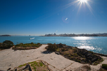 A view from Alcatraz Island shows the San Francisco skyline and the Golden Gate Bridge on a sunny day.