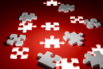 A single white jigsaw piece next to a completed puzzle with an empty space represents inspiration, ideas, planning, and a desired goal.