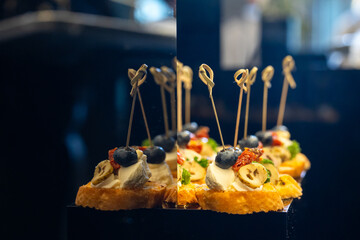 Canapes with feta cheese blueberry banana on bread base elegant appetizers for event.