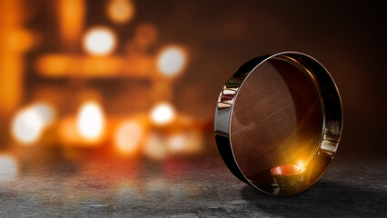 Sieve or strainer with a diya oil lamp for Karwa Chauth festival celebration on blurred bokeh light...