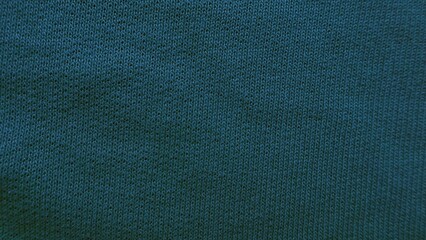 deep teal knitted fabric texture with soft woven pattern and subtle shadows for modern wallpaper or...