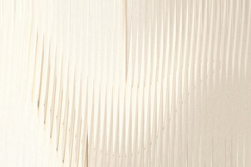 A closeup view of a textured surface with vertical lines and subtle variations in shade, creating an abstract and organic pattern