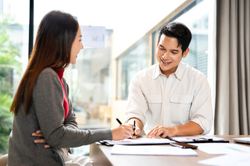  Two businessmen sit at desk discuss project details,colleagues met in office, share opinion, working on collaborative task, sales manager makes commercial offer to company client.