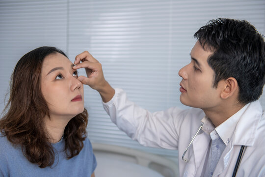 Doctor examining patient's eye in medical clinic