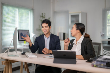 Business people discussing work using computer in office meeting