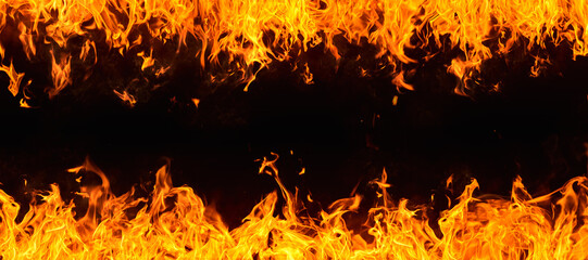 Frame of dramatic red, orange, yellow flames and smoke rising against a dark background. Realistic, abstract fire burning background texture overlay. Vivid and hot hell or blazing fire wallpaper