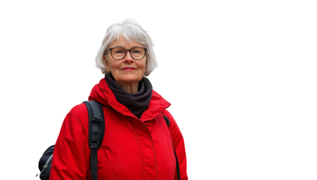 Senior woman wearing a bright red jacket with glasses stands confidently against a neutral background, showcasing vibrant style and individuality in fashion - Powered by Adobe