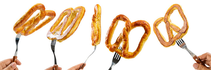 Collection set of human hands holding a salty baked brown pretzel with a fork isolated over a white background. Oktoberfest festival