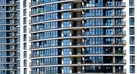 Building with blue windows in modern city landscape. Urban skyscraper exterior with geometric