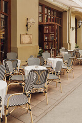 A charming outdoor dining area with unique patterned chairs, perfect for social gatherings