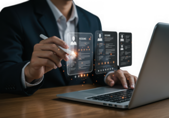Businessman interacting with holographic data displays and laptop