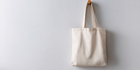 Minimalist Canvas Tote Bag Hanging on a Plain Wall for Custom Design and Personalization Eco Friendly Reusable Shopping Bag Mockup