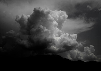 Dramatic Black and White Cloud Formation with Mountain Silhouette