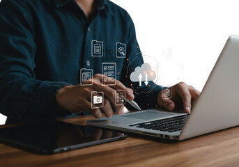 Person using laptop with digital cloud and data icons