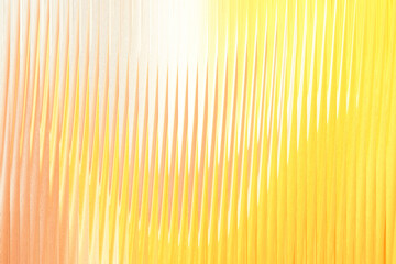 Fototapeta premium Abstract vertical lines of warm yellow and orange hues create a vibrant, textured background with a bright light source on the left