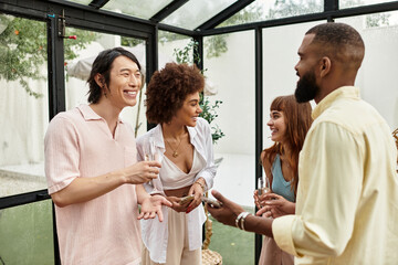 Friends share laughter and joy at an outdoor cafe during a sunny gathering