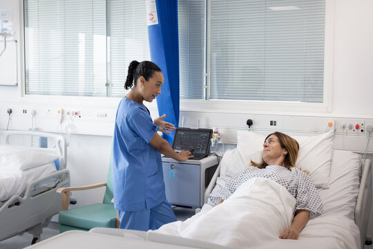 Doctor Discusses Care Plan with Patient in Bed
