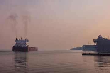 A Ship Leaving Ore Docks On Lake Superior During A Wildfire Smokey Hazy Evening