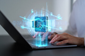 Photo of a persons hands typing on a laptop with a glowing digital safe and security network overlay