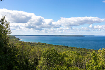 View of Georgian Bay from Grieg's Caves in Ontario, showcasing the breathtaking scenery of lush forests meeting the expansive blue waters.