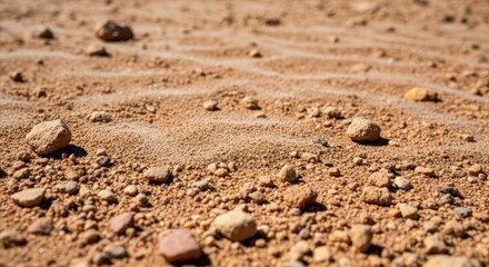 Dry cracked earth texture with pebbles and sand close up