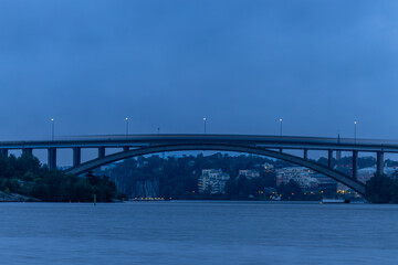 Naklejka premium Stockholm, Sweden A tunnelbana or subway train passes over the Tranebergsbron in the early morning.