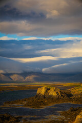 Dramatic Icelandic coastline with rocky shore and mountains