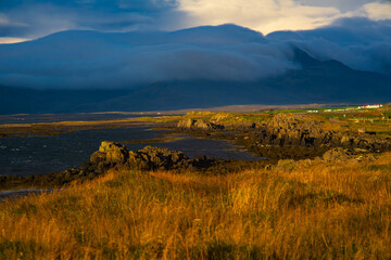 Golden Sunset Over Icelandic Coastline with Dramatic Clouds