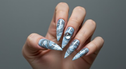 Elegant stiletto nails featuring a detailed blue serpent design and a glistening clear gem, showcasing modern hand fashion