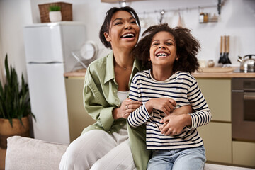 Joyful moments shared between mother and daughter in a cozy home setting