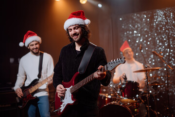 Musicians performing at holiday concert with festive hats