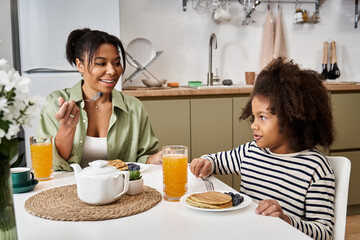 Mom and daughter enjoy a cozy breakfast together at home filled with joy and love