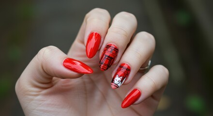 Elegant autumn nail art with a tartan design and a symbolic white maple leaf on red nails