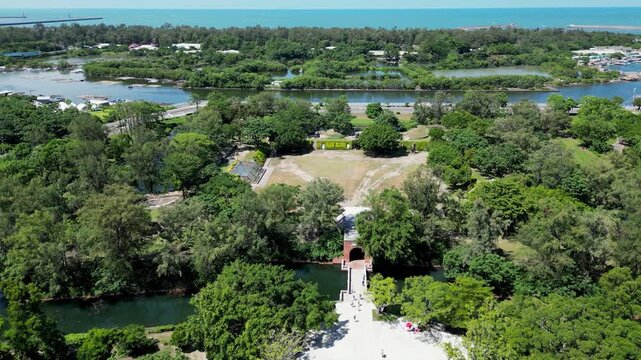 Aerial drone view of the historic Eternal Golden Castle (Erkunshun Fortress) and moat, with the Anping Harbor cityscape in summer. Tainan, Taiwan.