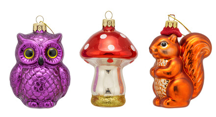 Fototapeta premium Colorful vintage glass Christmas ornaments including a purple owl, red mushroom, and orange squirrel, perfect for holiday decoration collections