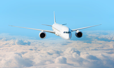 White passenger airplane flying in the sky amazing clouds in the background - Travel by air transport