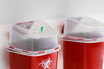 Stuck medical needle in biohazard sharps disposal container