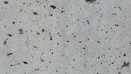 Textured Concrete Surface Featuring an Array of Air Pockets and Imperfections, Showcasing Urban Aesthetics and Industrial Design