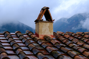 Roof in tiles and typical Tuscan chimney