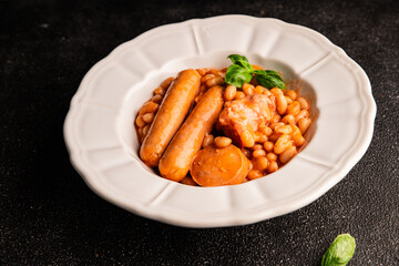 Cassoulet beans with meat and sausage french cuisine vegetables dish natural product tasty snack fresh delicious gourmet food background on the table rustic top view copy space