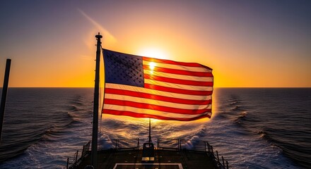 American flag waving proudly over the ocean at sunset from a ship's deck.