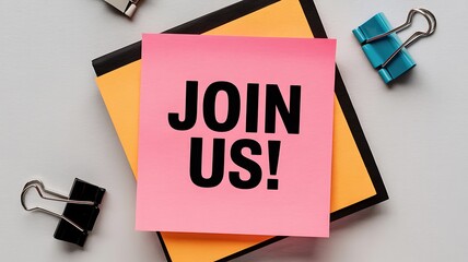 Join us! Pink memo note on desk invites new members to team or event, perfect for recruitment campaigns, partnership announcements, and community building initiatives